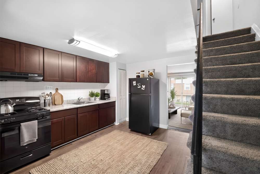 Kitchen with black appliances at Pleasant View Townhomes in Baltimore, Maryland