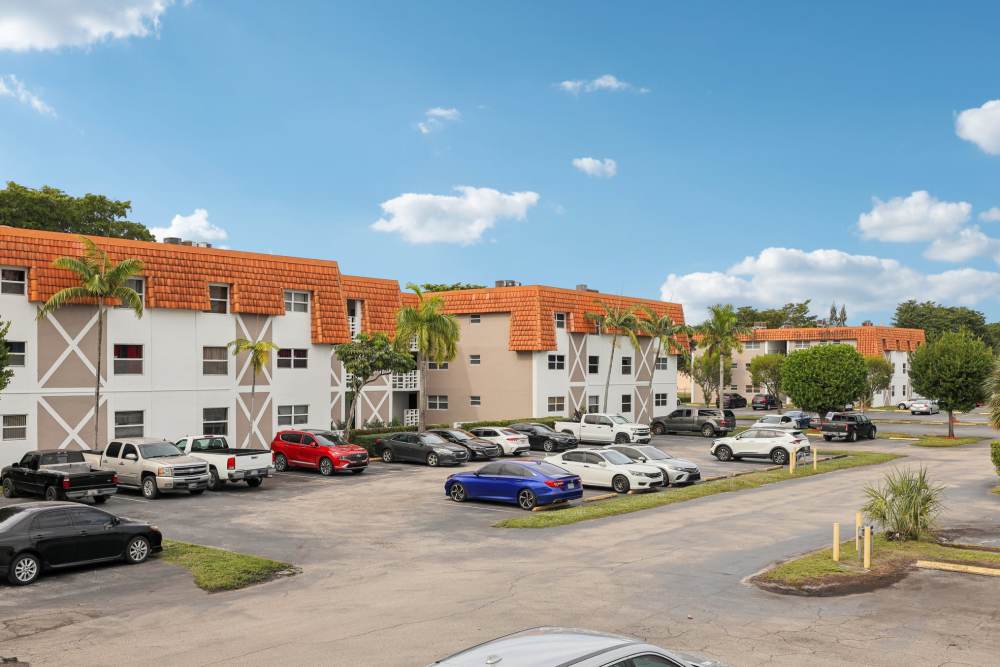 Exterior view of apartments with parking view at El Jardin Apartments in Hollywood, Florida