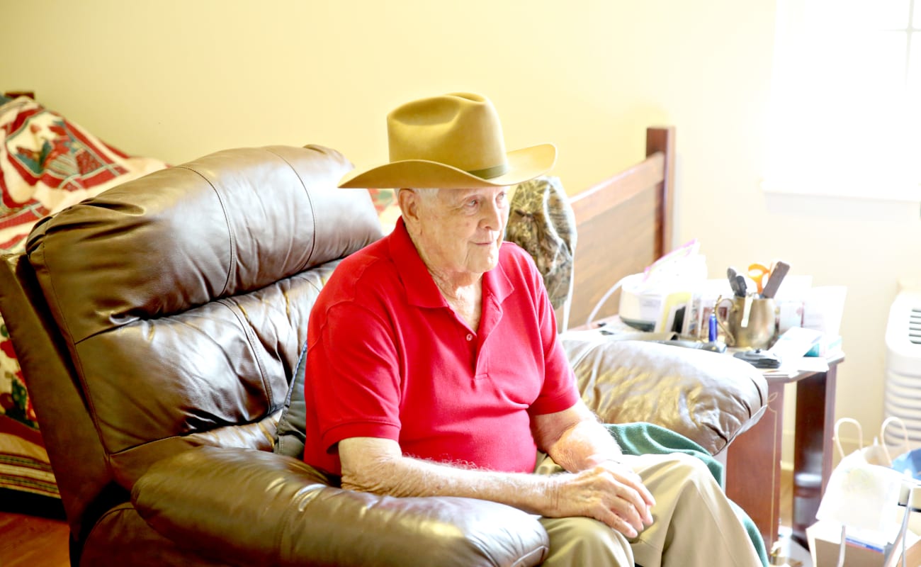 A male resident relaxing, sitting on his chair at Providence Assisted Living in Searcy, Arkansas