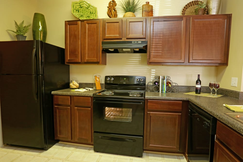 Granite countertops and black appliances in a model home's kitchen at Cahaba Grandview in Birmingham, Alabama