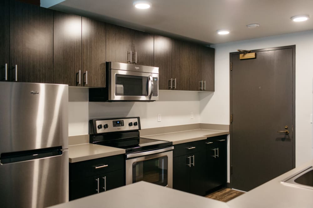 Modern kitchen with stainless steel appliances at MOD Apartments in Seattle, Washington