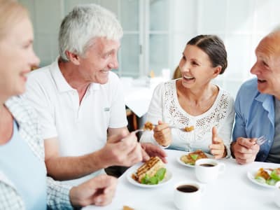 Residents drinking coffee and eating breakfast at Kenmore Senior Living in Kenmore, Washington