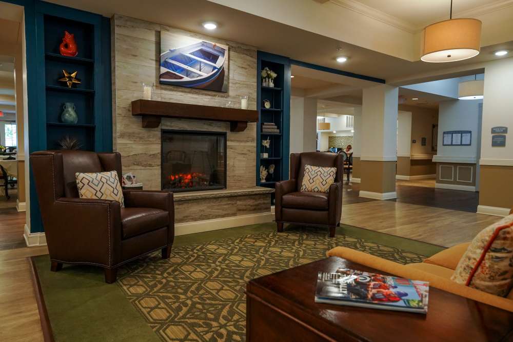 Common living area with sofas and fireplace at Harmony on the Peninsula in Yorktown, Virginia