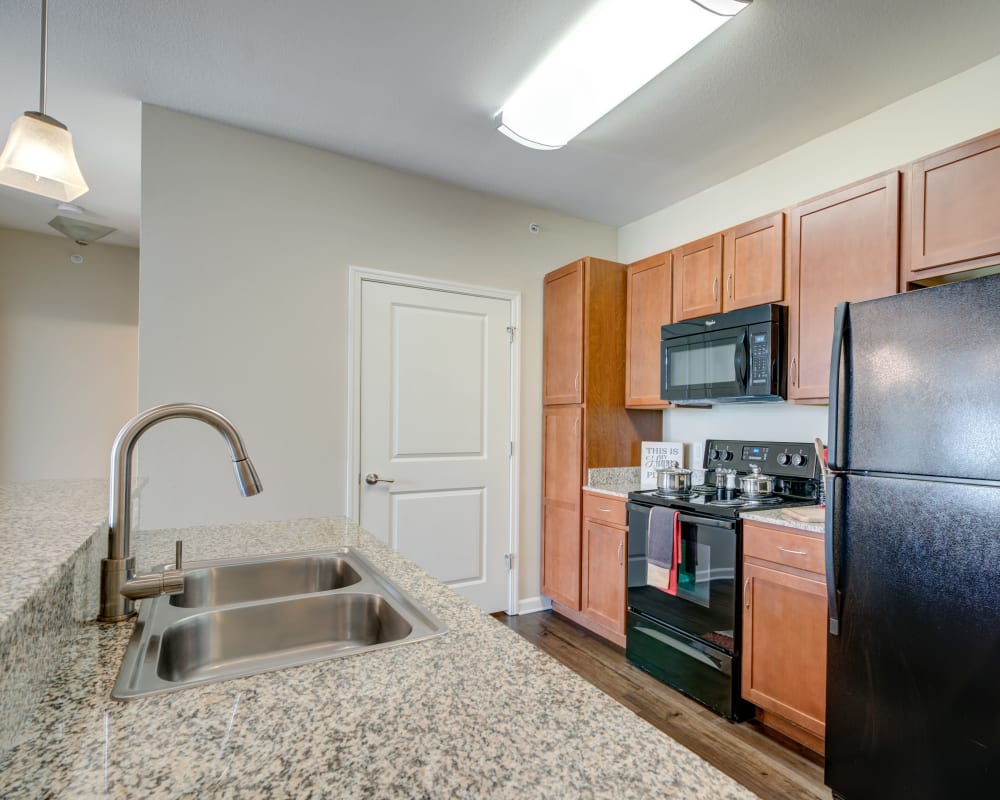 Modern kitchen looking into open-concept living area of model home at Cantare at Indian Lake Village in Hendersonville, Tennessee
