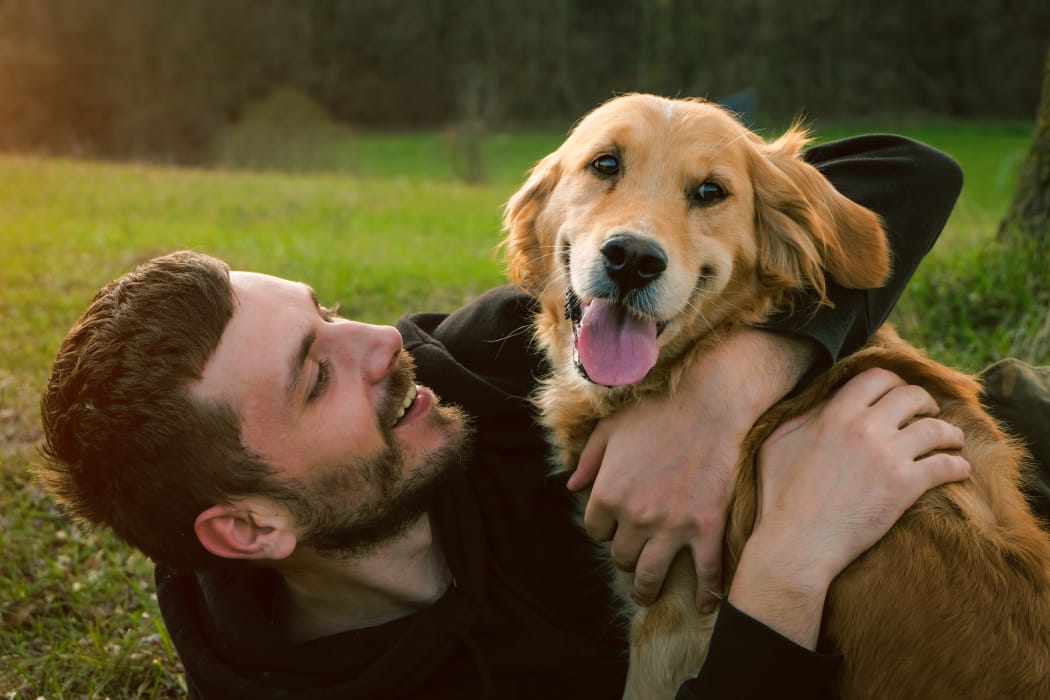 Man hugging his lovely dog at Crescent Oaks in Graham, North Carolina