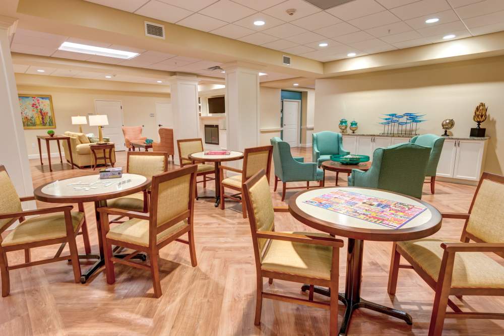 Common area with cozy seating and game tables at Barclay House of Stuart in Stuart, Florida