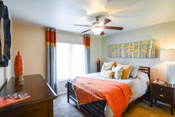 Large bedroom with orange accents at The Palms on Scottsdale in Tempe, Arizona