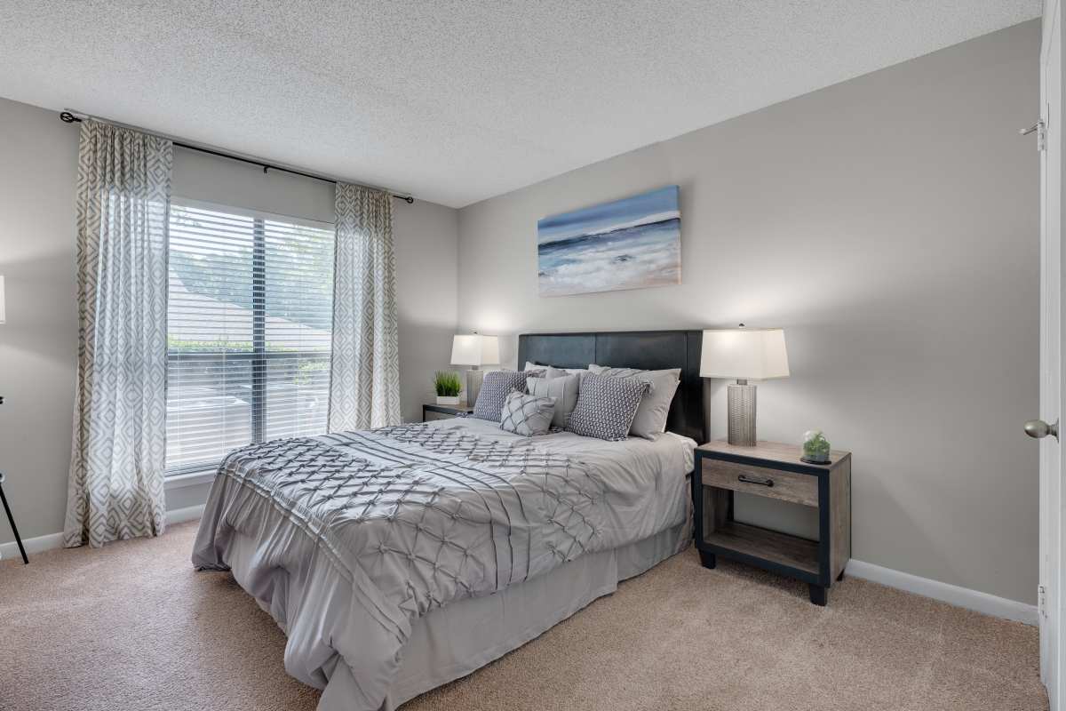 Bedroom with a comfortable bed at The Retreat at Lake Johnson Apartments, Raleigh, North Carolina