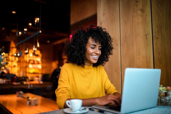 Resident working from a cafe near Emerald Park Apartment Homes in Dublin, California