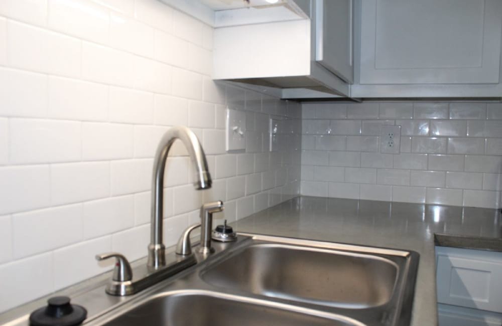 White, tile backsplash in a kitchen at Killan Hill in Snellville, Georgia