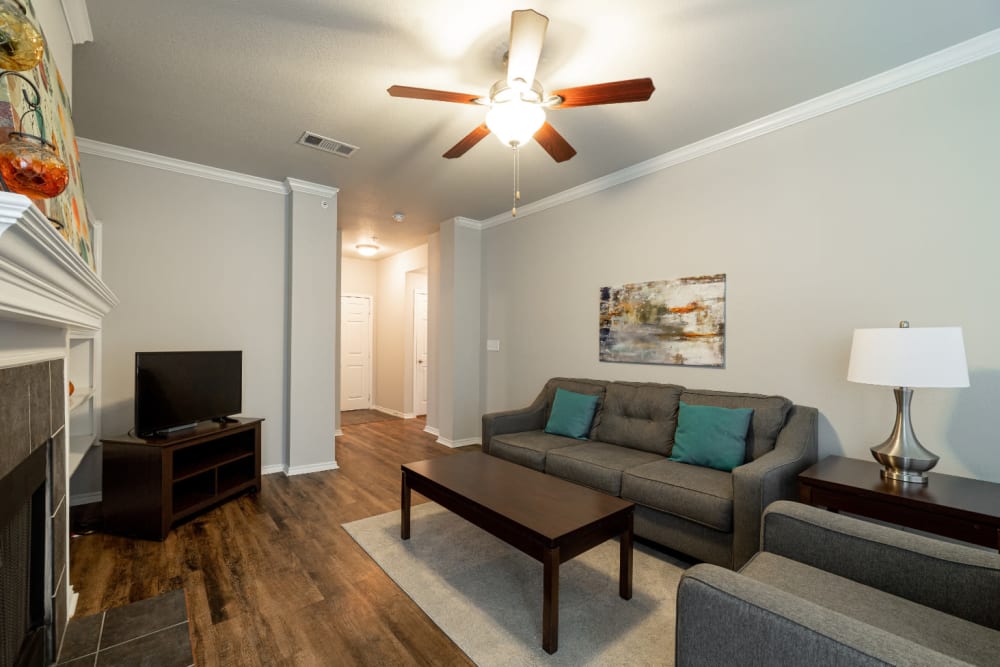 Bright living room with fireplace at Marquis at Bellaire Ranch in Fort Worth, Texas