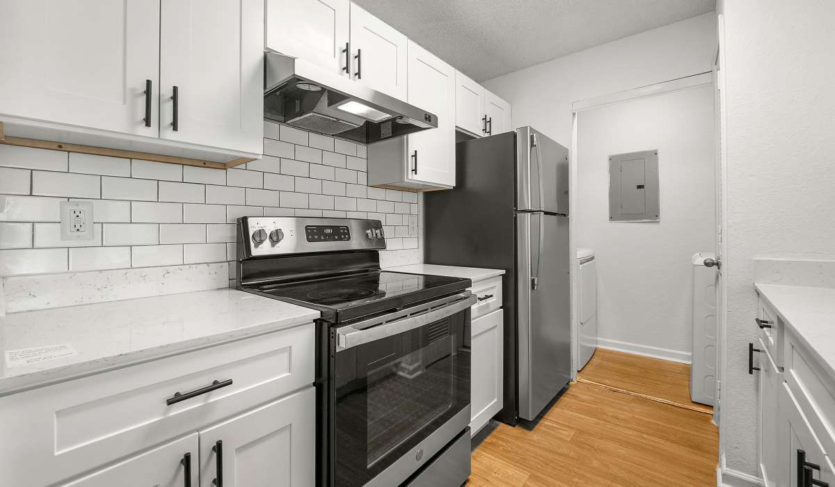 Apartment kitchen with fridge and oven at Eastlake Gardens in Decatur, Georgia