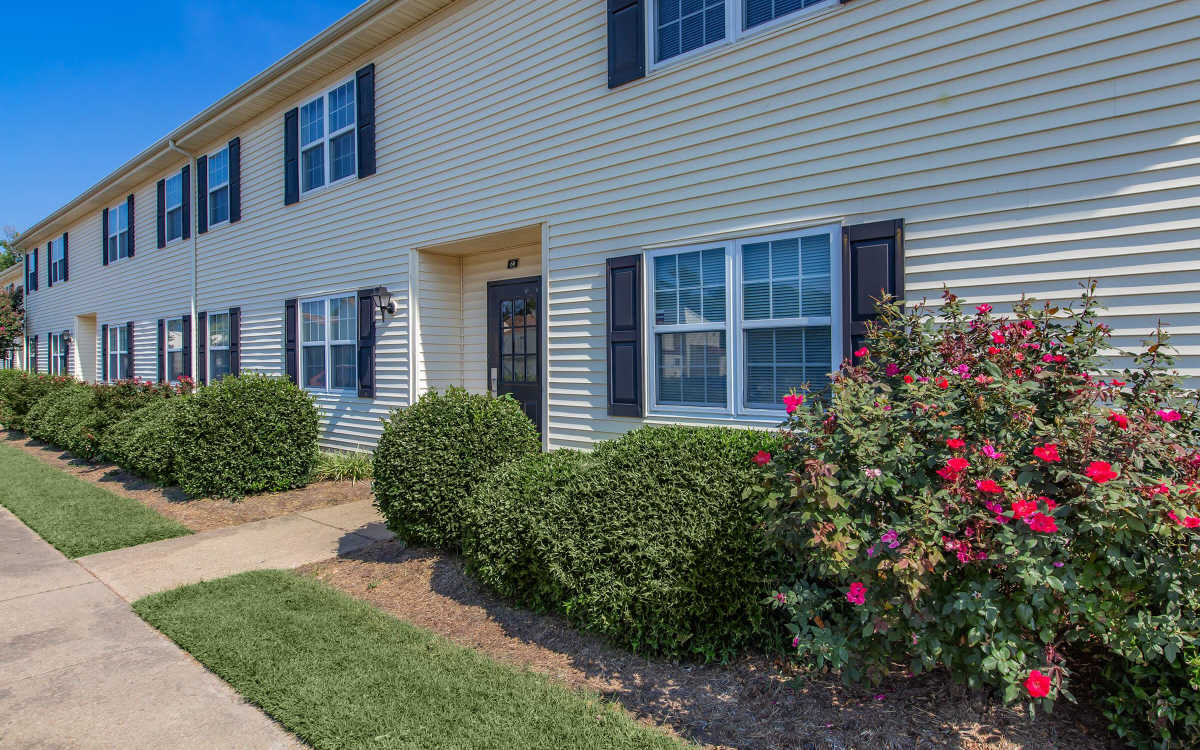 A beautiful outdoor view of the apartment building at Village at Town Park in Hampton, Virginia
