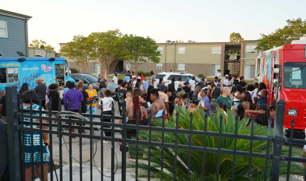 Residents falling in line to food trucks at Emerald Pointe Apartment Homes in Harvey, Louisiana