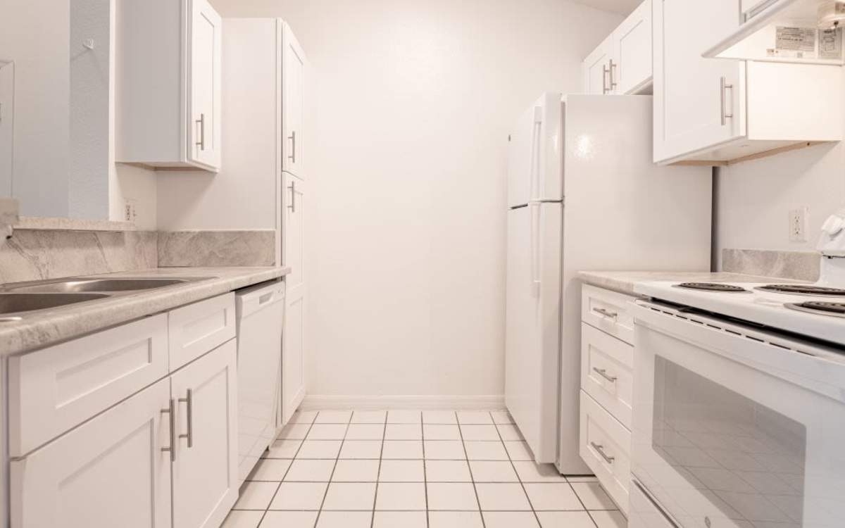 Modern kitchen with white appliances at Stratford Point in Sanford, Florida