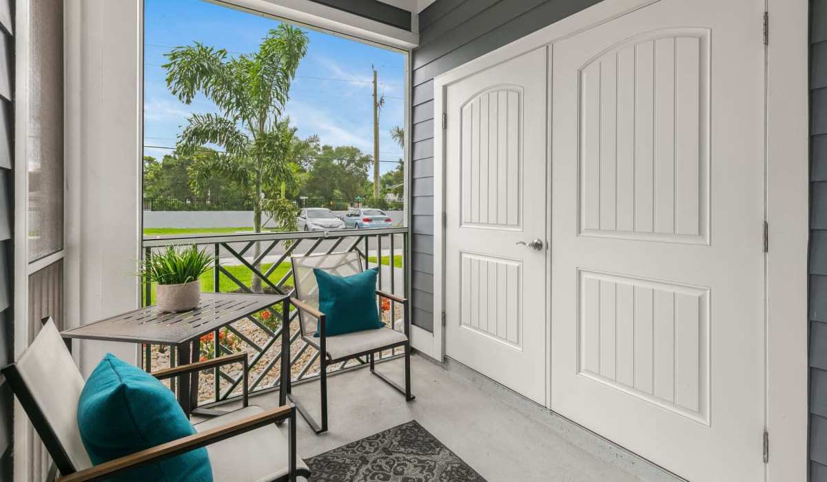 Private balcony with cozy seating area at The Bergamot Apartments On 780 in Sarasota, Florida