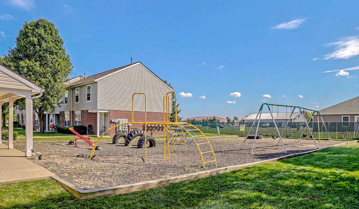 Playground area with swings and climbing structures near Glennview Apartments in Washington Court House, Ohio