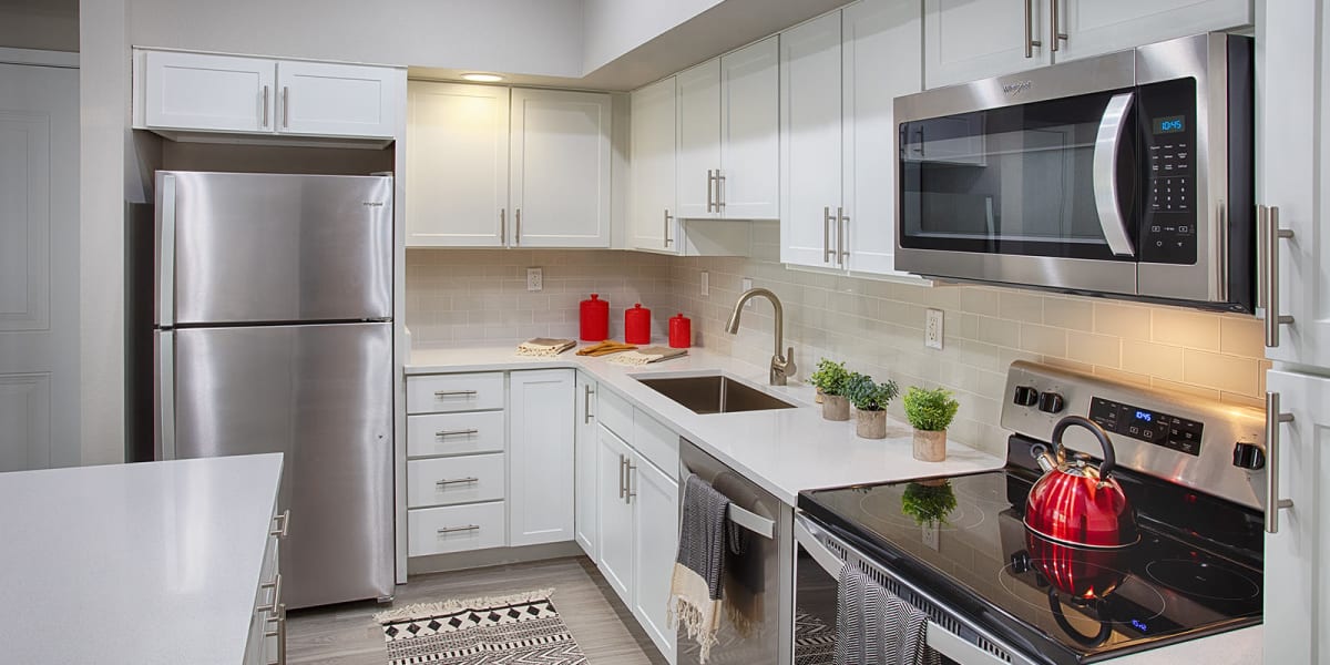 Kitchen with stainless steel appliances and granite counters at The Greens at Van de Water in Loveland, Colorado