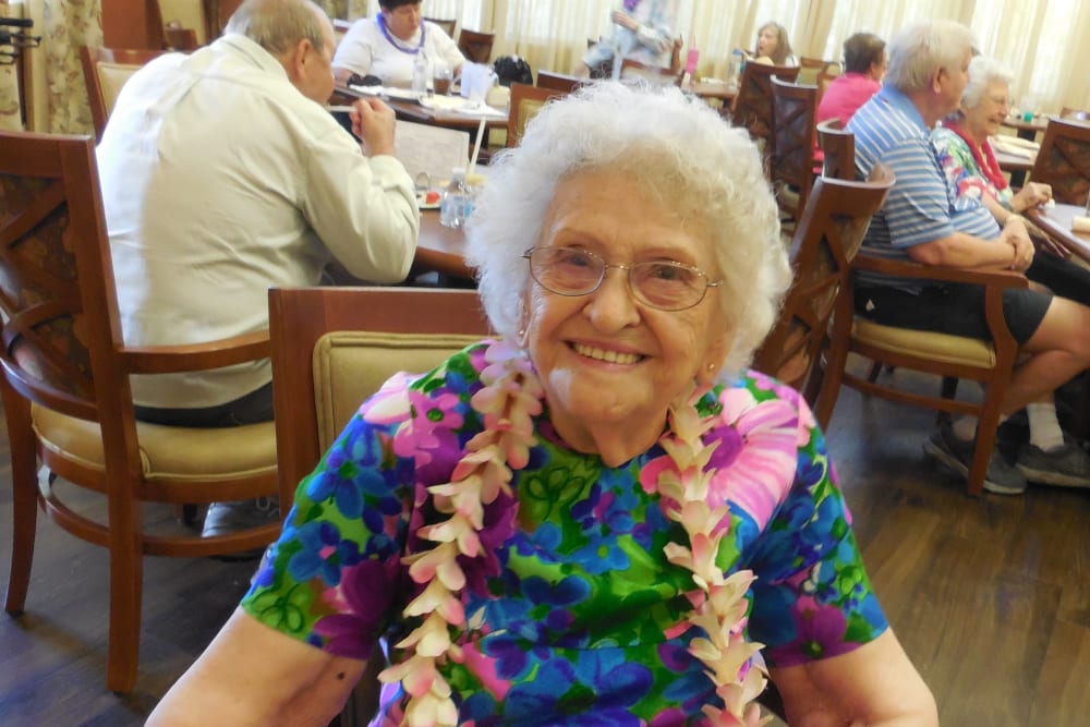A resident at a luau at The Groves, A Merrill Gardens Community in Goodyear, Arizona.