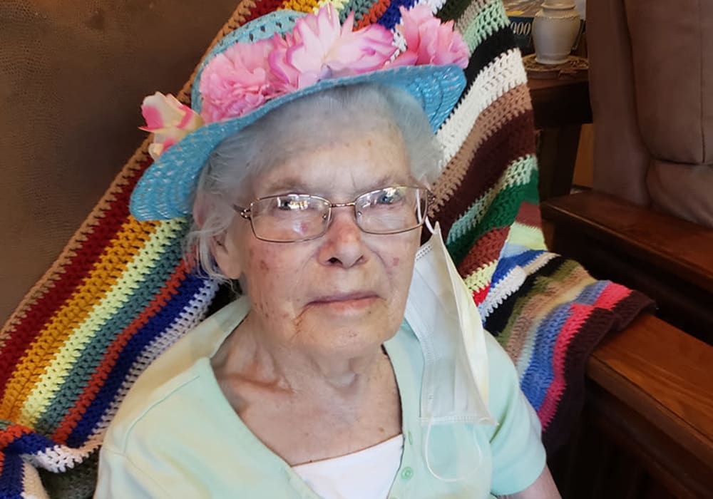 Happy resident with a self decorated hat at The Residences on Forest Lane in Montello, Wisconsin