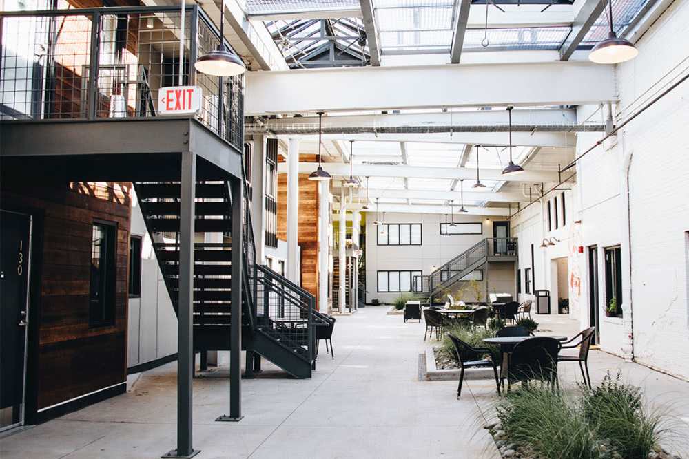 Gated entrance with outdoor seating area at Courtyard Lofts at Scott’s Addition in Richmond, Virginia