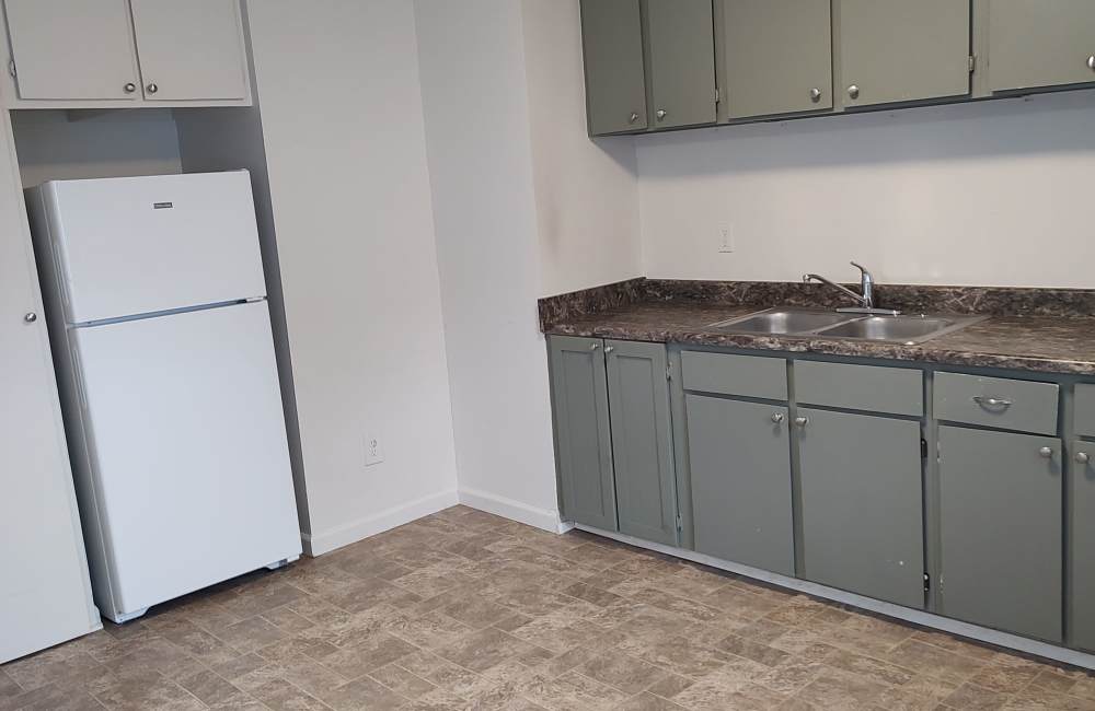 Kitchen with grey cabinets at Rawley Manor