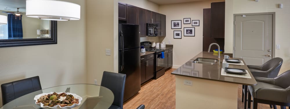 An open kitchen and dining room at M2 Apartments in Denver, Colorado