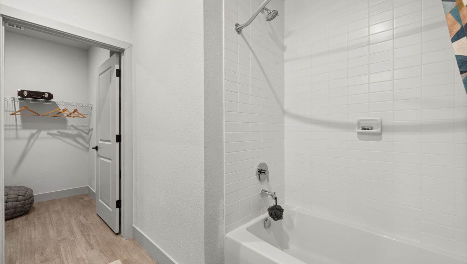 Bathroom with bathtub and access to closet at The Lock at Flatirons in Broomfield, Colorado