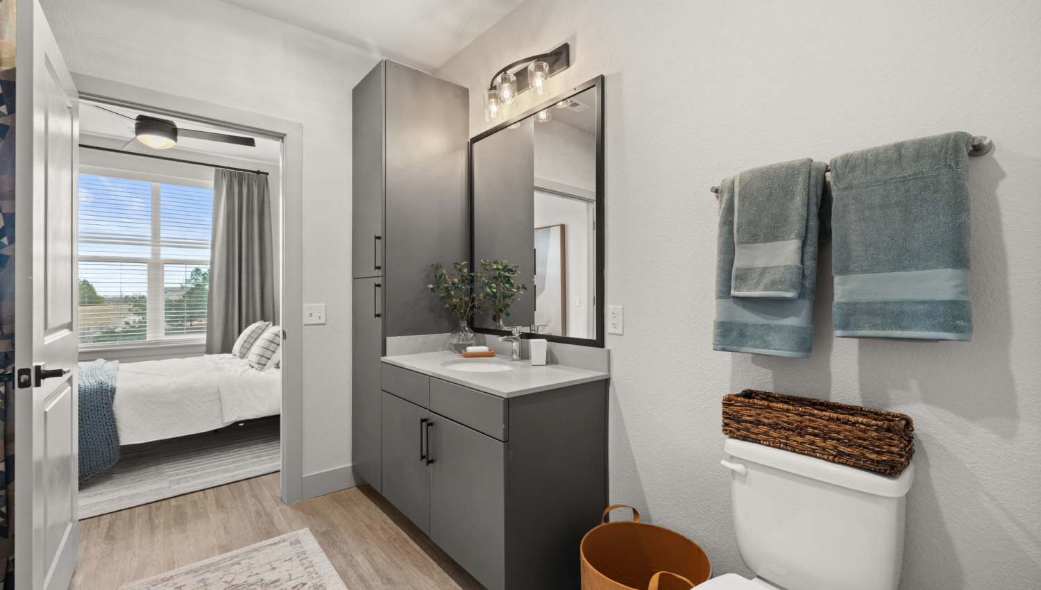 Apartment bedroom with attached bathroom at The Lock at Flatirons in Broomfield, Colorado