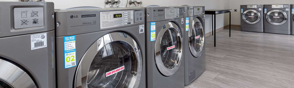 A row of washing machines in the community laundry room at Silver Creek Crossing in Austell, Georgia