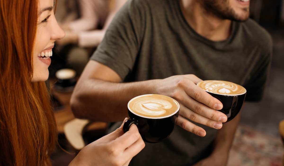 Woman and man drinking coffee near Belmont Estates in Arlington, Texas