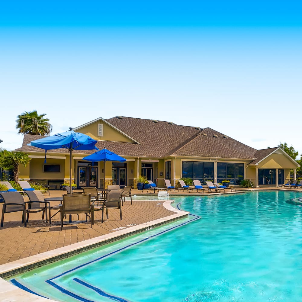 Swimming pool and outdoor recreation area at Grand Villas Apartments in Katy, Texas