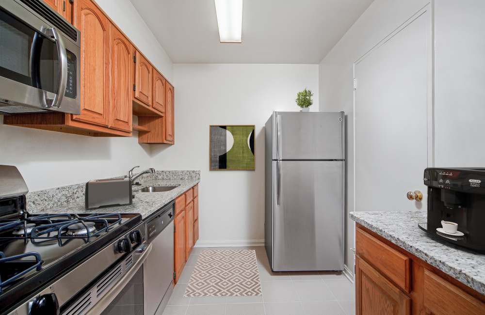 Modern kitchen with granite countertops in a model apartment at Bradley View Apartments in Chevy Chase, Maryland