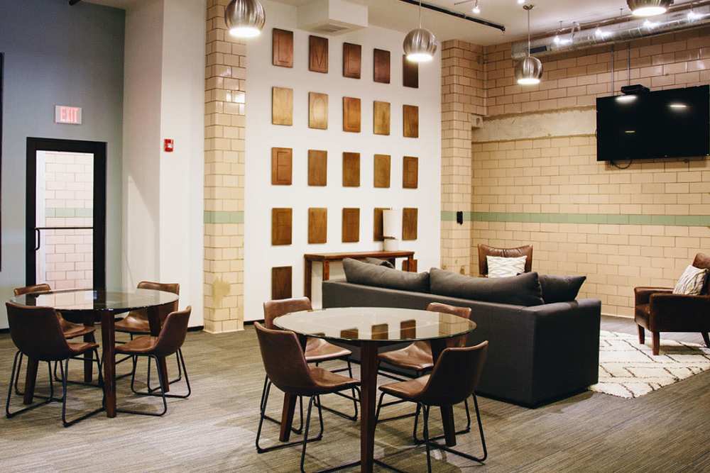 Modern lounge with glass tables and cozy seating at Courtyard Lofts at Scott’s Addition in Richmond, Virginia