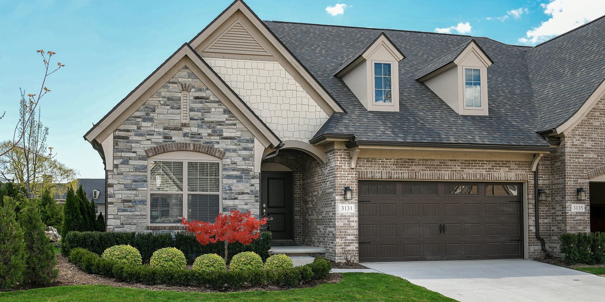 Elegant home with two car garage and well maintained lawn at Blossom Collection in Rochester, Michigan