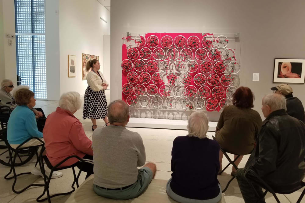 Residents looking at art near Inspired Living Ivy Ridge in St Petersburg, Florida.