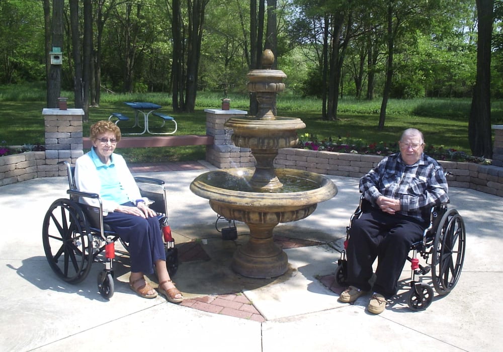 Residents enjoying the outdoor fountain and sunshine at Montello Care Center in Montello, Wisconsin