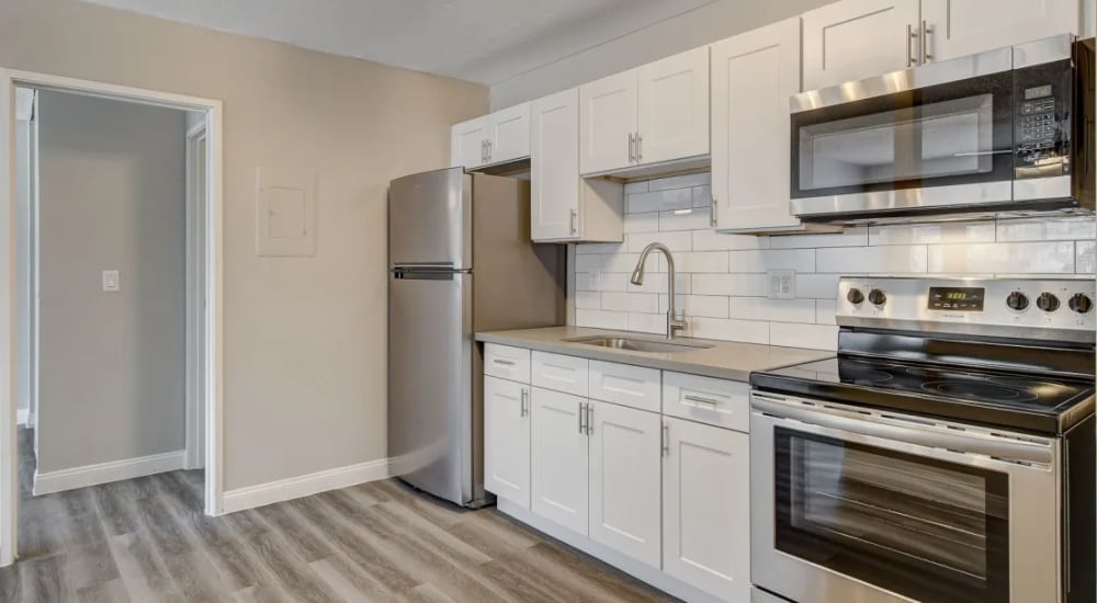 Kitchen with wood-style flooring at Tides at Spring Mountain in Las Vegas, Nevada