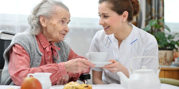 Resident enjoying breakfast with their caretaker at East Troy Manor in East Troy, Wisconsin