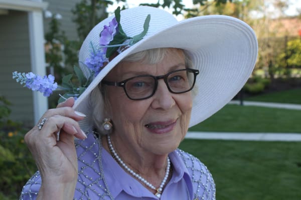 Patty a resident in a beautiful white hat at Springwood Landing Gracious Retirement Living in Vancouver, Washington