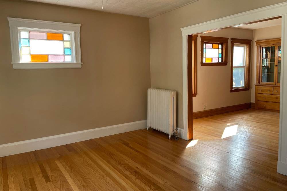Unfurnished living room with wood-style flooring at Housing Corp of Arlington in Arlington, Massachusetts