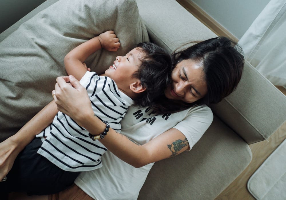 Resident cuddling with her child at Sandy Fifty One in Portland, Oregon