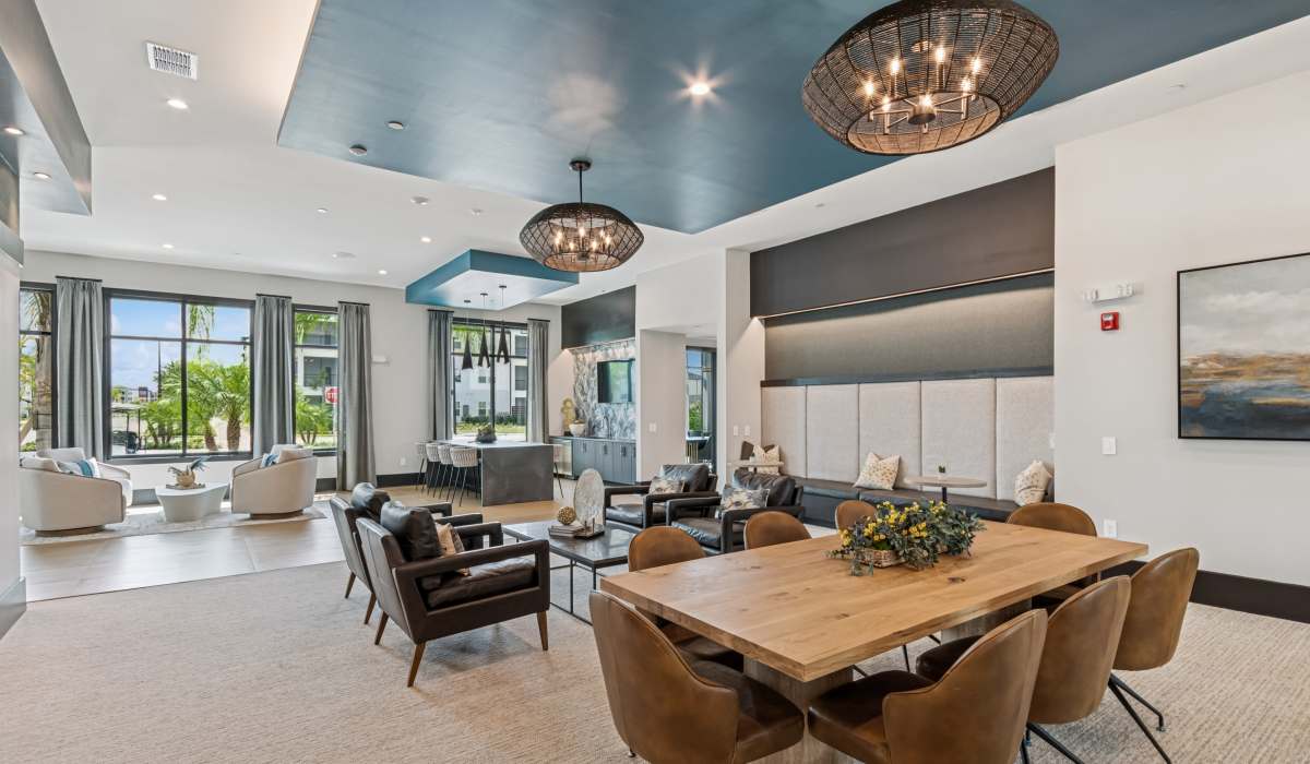 Community lounge area with seating and tables at Savelle Nona West in Orlando, Florida