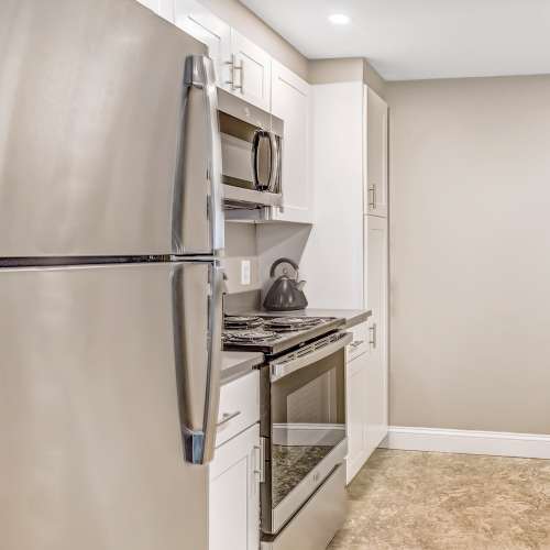 Kitchen with white cabinetry at Station 101 in Beverly, Massachusetts