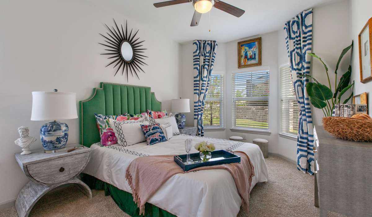 Bright bedroom with large windows at Sadler House in San Marcos, Texas