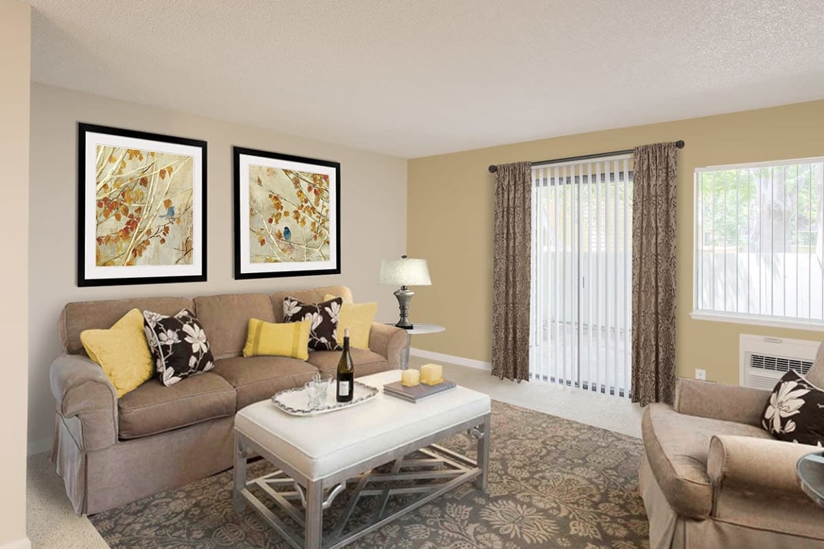 Couch and plants in a living room at The Crossing At Arroyo Trail in Livermore, California