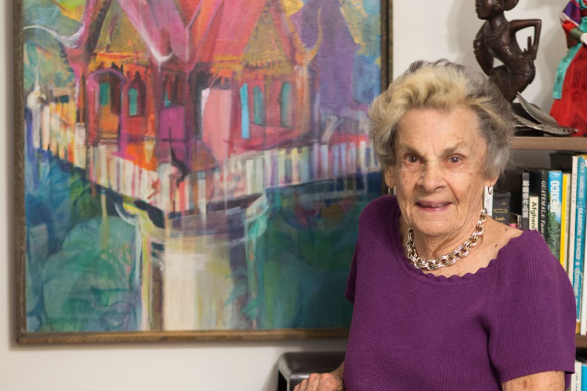 A resident standing in front of a painting at Gables of Ojai in Ojai, California
