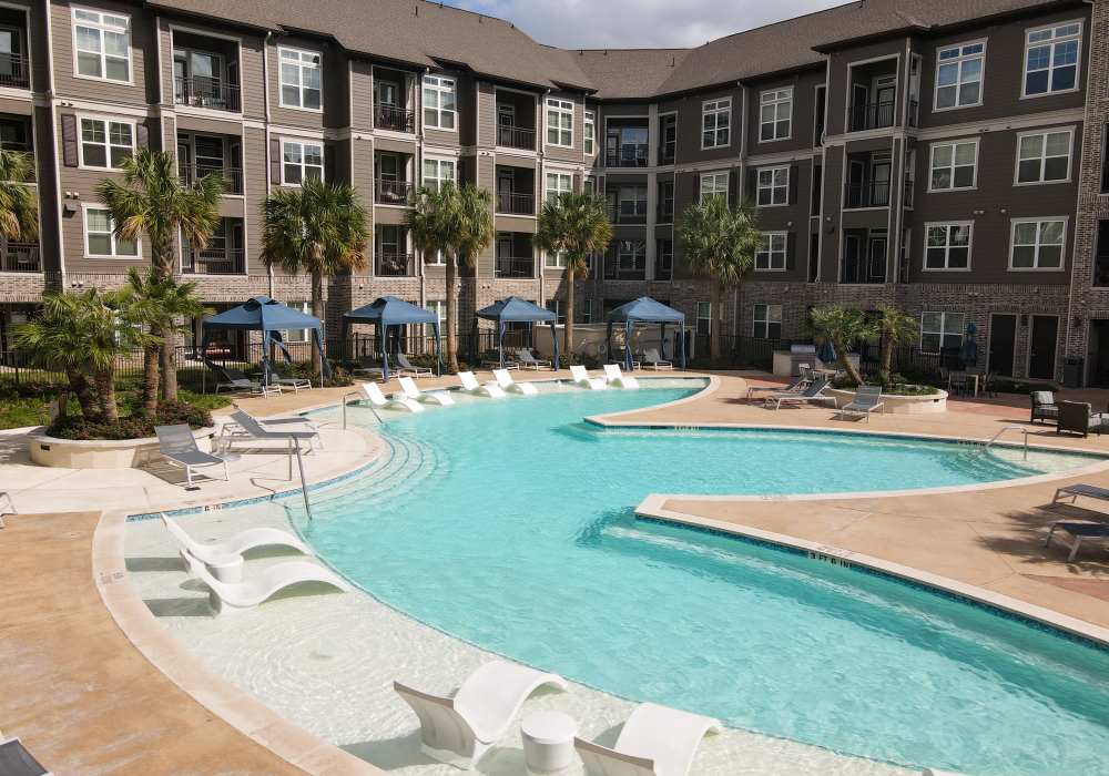 Resort-style swimming pool with sundeck at Orleans at Fannin Station in Houston, Texas