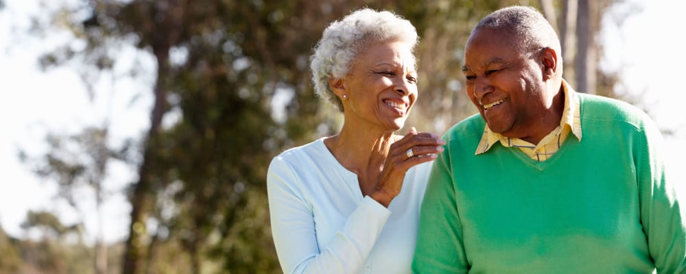 Resident couple walking outside together at The Springs at Lake Oswego in Lake Oswego, Oregon
