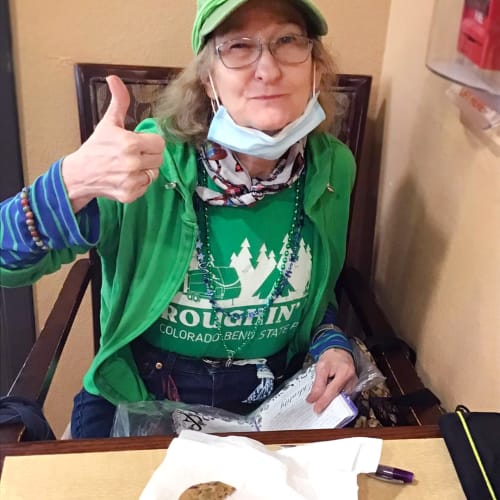 Resident eating cookies at Oxford Glen Memory Care at Grand Prairie in Grand Prairie, Texas